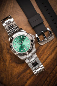 Thumbnail for Oceaneva 1250M Dive Watch Aquamarine On Bracelet Wooden Table